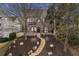 Charming brick home featuring a stone pathway, manicured landscaping, and beautiful architectural details at 239 E Wesley Ne Rd, Atlanta, GA 30305