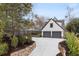 Elegant home featuring a two-car garage, well-maintained landscaping, and a stone retaining wall at 239 E Wesley Ne Rd, Atlanta, GA 30305