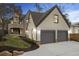 Charming home with a brick and siding exterior, two-car garage, and beautifully landscaped yard at 239 E Wesley Ne Rd, Atlanta, GA 30305
