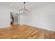 Elegant living room featuring hardwood floors, wainscoting details, chandelier, and staircase view at 239 E Wesley Ne Rd, Atlanta, GA 30305
