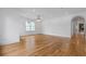 Open living room features hardwood floors and a view through an arched doorway at 239 E Wesley Ne Rd, Atlanta, GA 30305