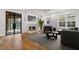 Inviting living room featuring a fireplace, large windows, and comfortable seating, creating a warm and welcoming ambiance at 239 E Wesley Ne Rd, Atlanta, GA 30305
