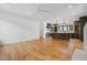 Open-concept living room with hardwood floors leading into a kitchen with an island at 239 E Wesley Ne Rd, Atlanta, GA 30305