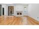 Cozy living room with fireplace, hardwood floors, and access to a terrace through black framed doors at 239 E Wesley Ne Rd, Atlanta, GA 30305