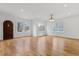 Living room featuring hardwood floors, multiple windows, and a dark wood door at 239 E Wesley Ne Rd, Atlanta, GA 30305