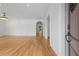 Bright living room features hardwood floors, an elegant chandelier, and a view through arched doorway at 239 E Wesley Ne Rd, Atlanta, GA 30305