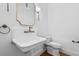 Charming powder room features a vintage-style sink with brass fixtures and a decorative mirror at 239 E Wesley Ne Rd, Atlanta, GA 30305