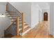 Staircase with wood treads and dark metal railings, leading to an arched hallway at 239 E Wesley Ne Rd, Atlanta, GA 30305