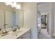 Neutral bathroom with a white vanity, large mirror, and a view into an adjacent room at 3081 Dickson St, Brookhaven, GA 30319