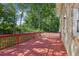 Large red wooden deck, fenced-in yard, surrounded by mature trees, excellent for entertaining and relaxing at 1231 Sanden Ferry Dr, Decatur, GA 30033