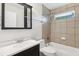 Bathroom featuring shower and tub combination with tiled walls and black fixtures at 1231 Sanden Ferry Dr, Decatur, GA 30033