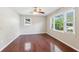 Bright bedroom with hardwood floors, a ceiling fan, and natural light from the double-paned windows at 1231 Sanden Ferry Dr, Decatur, GA 30033