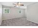 Spacious bedroom featuring neutral walls, plush carpeting, a ceiling fan, and two windows at 1231 Sanden Ferry Dr, Decatur, GA 30033