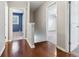 Hallway with hardwood floors showcasing entryways to rooms and ample natural light at 1231 Sanden Ferry Dr, Decatur, GA 30033