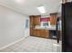 Bright kitchen with granite countertops, wood cabinets, tile flooring, and a door to the backyard at 1231 Sanden Ferry Dr, Decatur, GA 30033