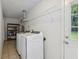 Bright laundry room with modern washer/dryer, utility sink, and storage shelves at 1231 Sanden Ferry Dr, Decatur, GA 30033