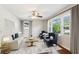 Sunlit living room showcasing hardwood floors, neutral paint, a ceiling fan, and an elegant seating arrangement at 1231 Sanden Ferry Dr, Decatur, GA 30033