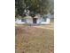 A cute, single-story home is framed by a large tree and walkway and freshly painted exterior at 136 Tye St, Stockbridge, GA 30281