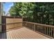 Private wooden back porch with brown wooden fence and view of trees at 1537 Liberty Nw Pkwy, Atlanta, GA 30318