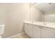 Bathroom with double vanity, white cabinets, large mirror, and tile flooring at 1537 Liberty Nw Pkwy, Atlanta, GA 30318