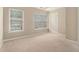 The bedroom has carpeted floors, two windows, and a white closet door at 1537 Liberty Nw Pkwy, Atlanta, GA 30318