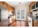 Well-equipped kitchen featuring stainless steel appliances, wooden cabinets, and a door to the backyard at 1537 Liberty Nw Pkwy, Atlanta, GA 30318