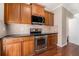 Modern kitchen with stainless steel appliances, wooden cabinets, and dark countertops at 1537 Liberty Nw Pkwy, Atlanta, GA 30318