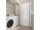 Laundry room featuring a washer, dryer, and shelving for storage at 1537 Liberty Nw Pkwy, Atlanta, GA 30318