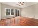 Spacious living room featuring hardwood floors, large windows with natural light, and a ceiling fan at 1537 Liberty Nw Pkwy, Atlanta, GA 30318