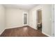 This room features hardwood floors, neutral walls, and a door to the outside at 1537 Liberty Nw Pkwy, Atlanta, GA 30318