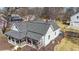 Aerial view of the charming two-story home with a cozy front porch and well-maintained roof at 2982 N Main Nw St, Kennesaw, GA 30144