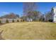 Large backyard featuring a shed, plenty of green grass, and mature trees on a sunny day at 2982 N Main Nw St, Kennesaw, GA 30144