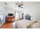 Bedroom featuring a bed, ceiling fan, closet, and dresser with TV at 2982 N Main Nw St, Kennesaw, GA 30144