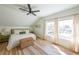 Bright bedroom featuring large windows, neutral decor, a ceiling fan, and beautiful hardwood floors at 2982 N Main Nw St, Kennesaw, GA 30144