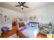 Bedroom with hardwood floors, ceiling fan, and a view into a bathroom at 2982 N Main Nw St, Kennesaw, GA 30144