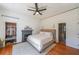 Bedroom featuring a large bed, ceiling fan, closet with shelving, and ensuite bathroom with glass shower at 2982 N Main Nw St, Kennesaw, GA 30144