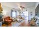 Living room area with hardwood floors, ceiling fan, and view of kitchen area at 2982 N Main Nw St, Kennesaw, GA 30144