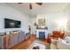 Living room with hardwood floors, fireplace, and tv mounted on wall at 2982 N Main Nw St, Kennesaw, GA 30144