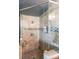 Glass enclosed shower featuring gorgeous tile, shower head, and tiled inset for soaps and shampoos at 2982 N Main Nw St, Kennesaw, GA 30144