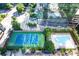 An aerial view showcases a tennis court, a pool, and a seating area, all surrounded by lush landscaping at 3445 Stratford Ne Rd # 1605, Atlanta, GA 30326