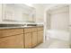 Bright bathroom featuring granite countertops, wood cabinets, and a tub with glass doors at 3445 Stratford Ne Rd # 1605, Atlanta, GA 30326