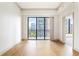 Spacious bedroom with hardwood floors and a large window overlooking the city at 3445 Stratford Ne Rd # 1605, Atlanta, GA 30326