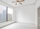 Bright bedroom with a ceiling fan and large window providing natural light and a city view at 3445 Stratford Ne Rd # 1605, Atlanta, GA 30326