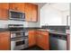 Efficient kitchen with stainless appliances, double oven, granite counters, and dark tile flooring at 3445 Stratford Ne Rd # 1605, Atlanta, GA 30326
