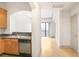 Kitchen view features granite countertops and stainless steel appliances looking toward the living room at 3445 Stratford Ne Rd # 1605, Atlanta, GA 30326