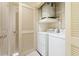 Functional laundry room with washer, dryer, and storage shelves at 3445 Stratford Ne Rd # 1605, Atlanta, GA 30326