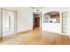 Open-concept living area with hardwood floors and an arched entry to the kitchen at 3445 Stratford Ne Rd # 1605, Atlanta, GA 30326