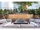 Outdoor lounge area featuring modern seating, a fire pit, and lush landscaping at 3445 Stratford Ne Rd # 1605, Atlanta, GA 30326