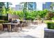 Outdoor kitchen and entertaining area with bar seating, grills, and dining tables at 3445 Stratford Ne Rd # 1605, Atlanta, GA 30326