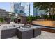 Upscale patio features cabanas, comfortable seating, a fire pit, water feature, and a modern building backdrop at 3445 Stratford Ne Rd # 1605, Atlanta, GA 30326